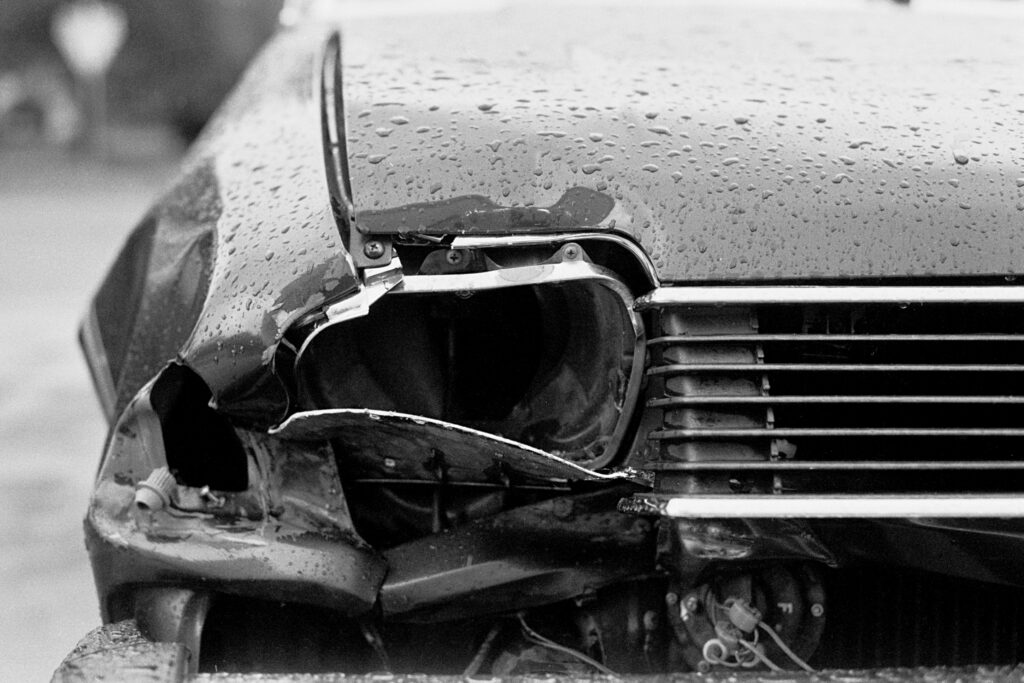 A broken headlight in the rain.